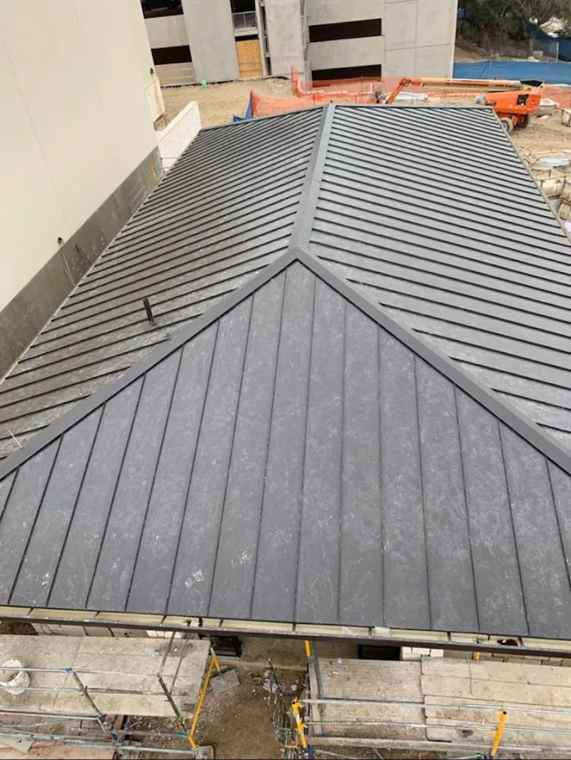 Commercial metal roof construction with crane equipment in Peoria