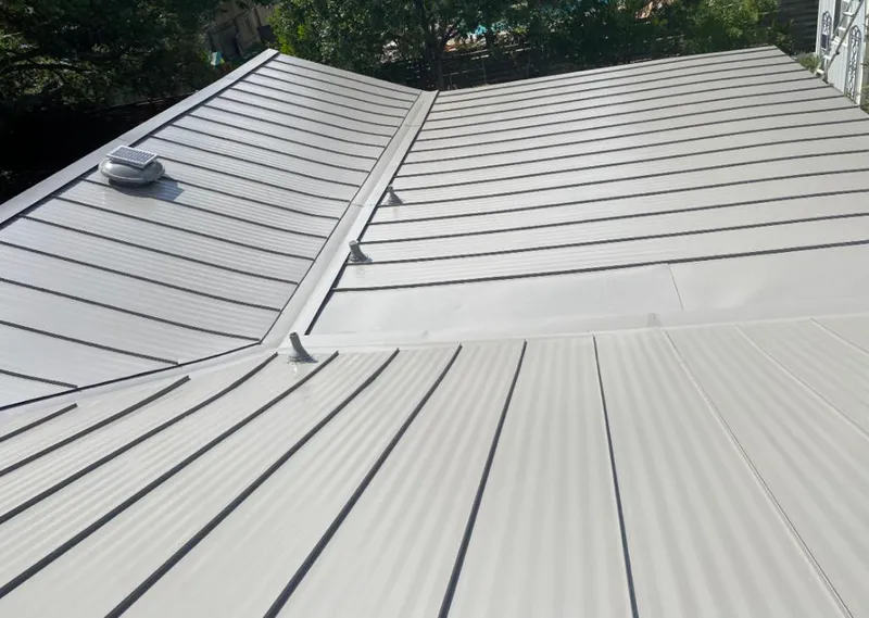 Solar attic fan installed on a metal roof for Roof Ventilation in Peoria